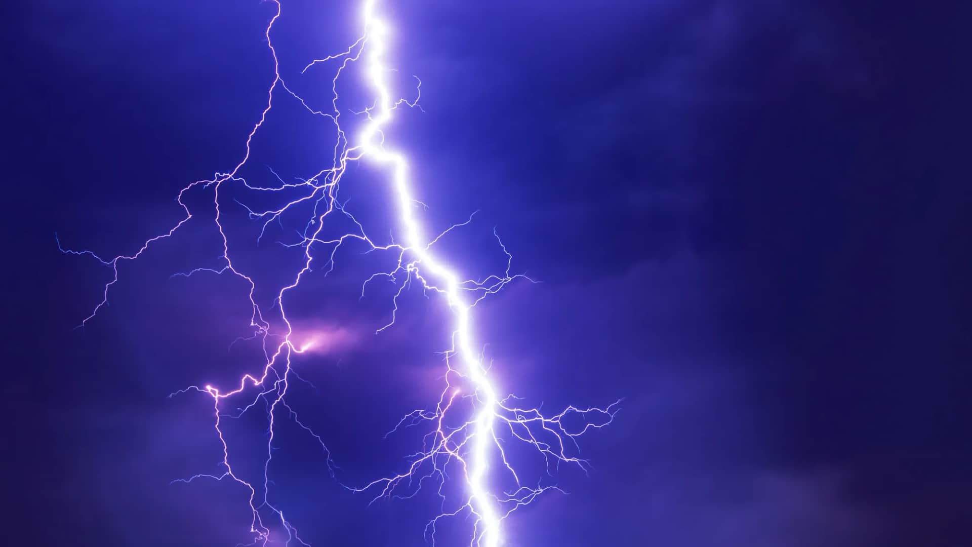 What is the real unit of organisational transformation?. A forked lightning bolt striking through a deep blue night sky