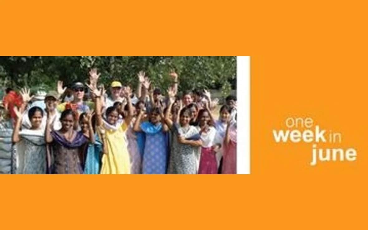 How can you build global team identity on a small budget?. One Week in June banner: a group outdoors with their hands raised in the air