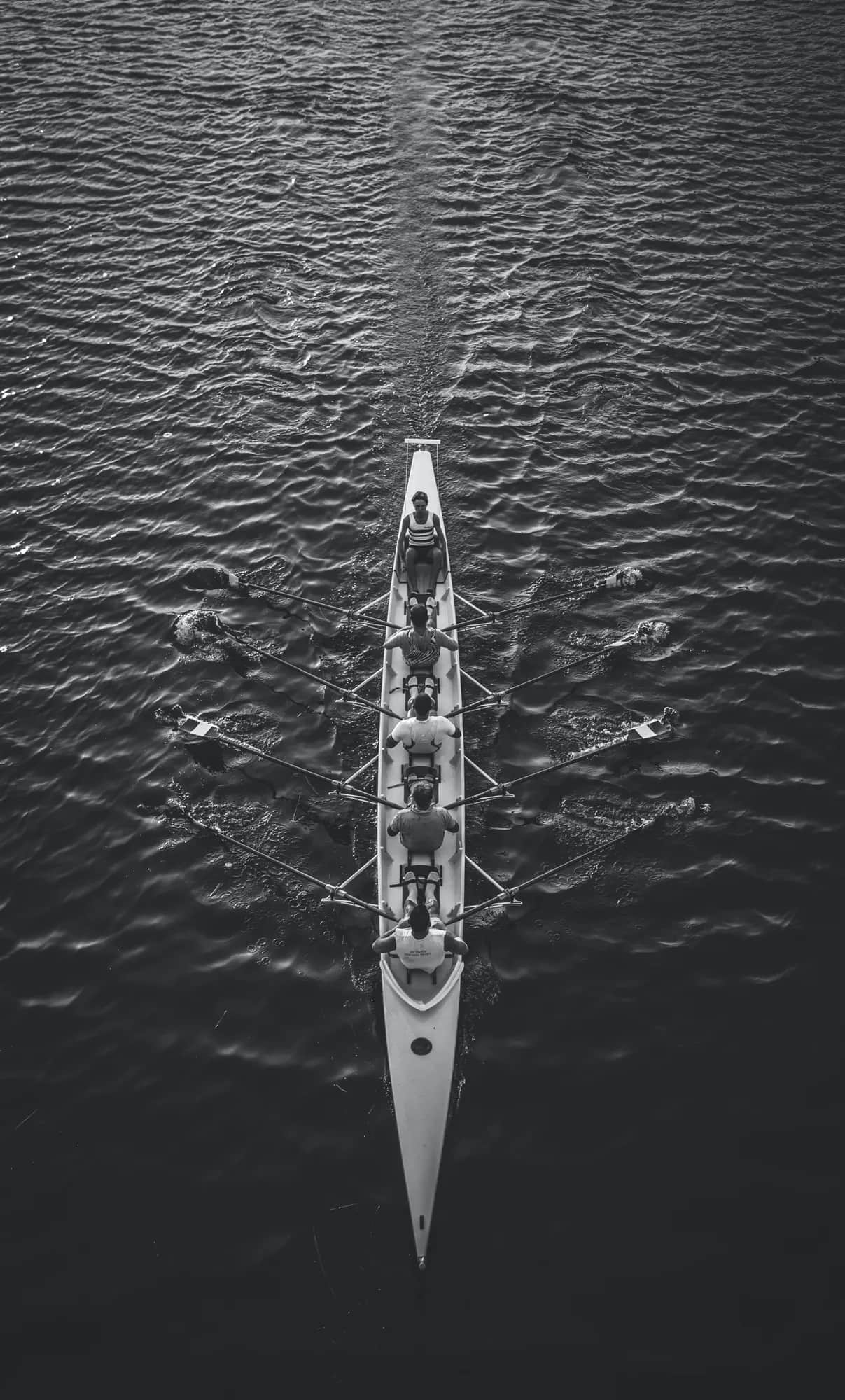 What can elite athletes teach us about sustaining performance at work?. Aerial view of a rowing eight pulling in unison down a river