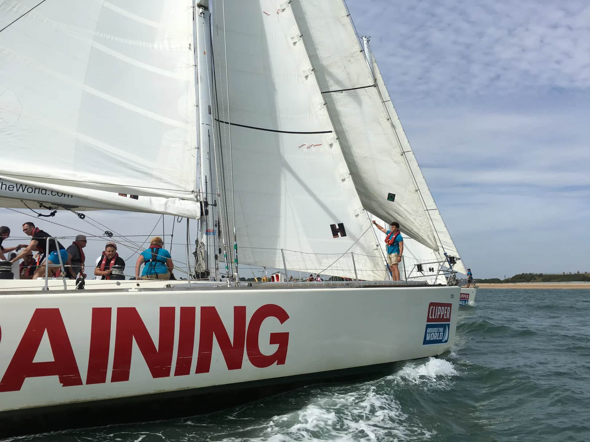 What can a sailing crew teach a business team?. Crew working the deck of a sail training yacht under full sail