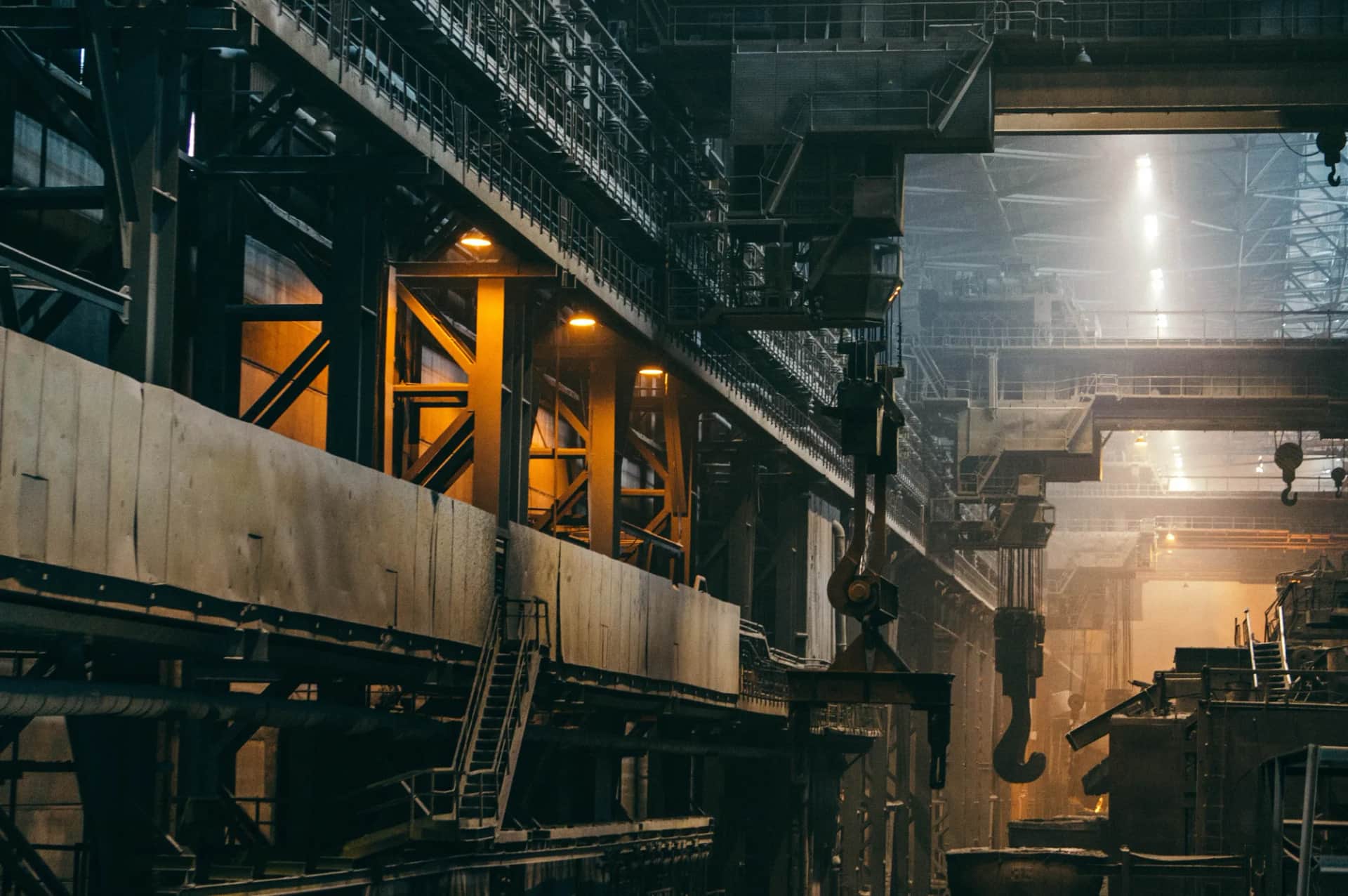 How do you restart a stalled Lean programme and boost manufacturing productivity?. The interior of a heavy industrial plant, gantries and machinery under work lights