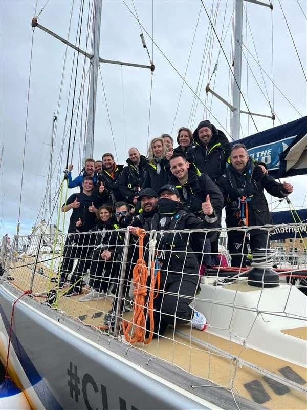 A Mission Performance crew in sailing kit on the deck of a yacht
